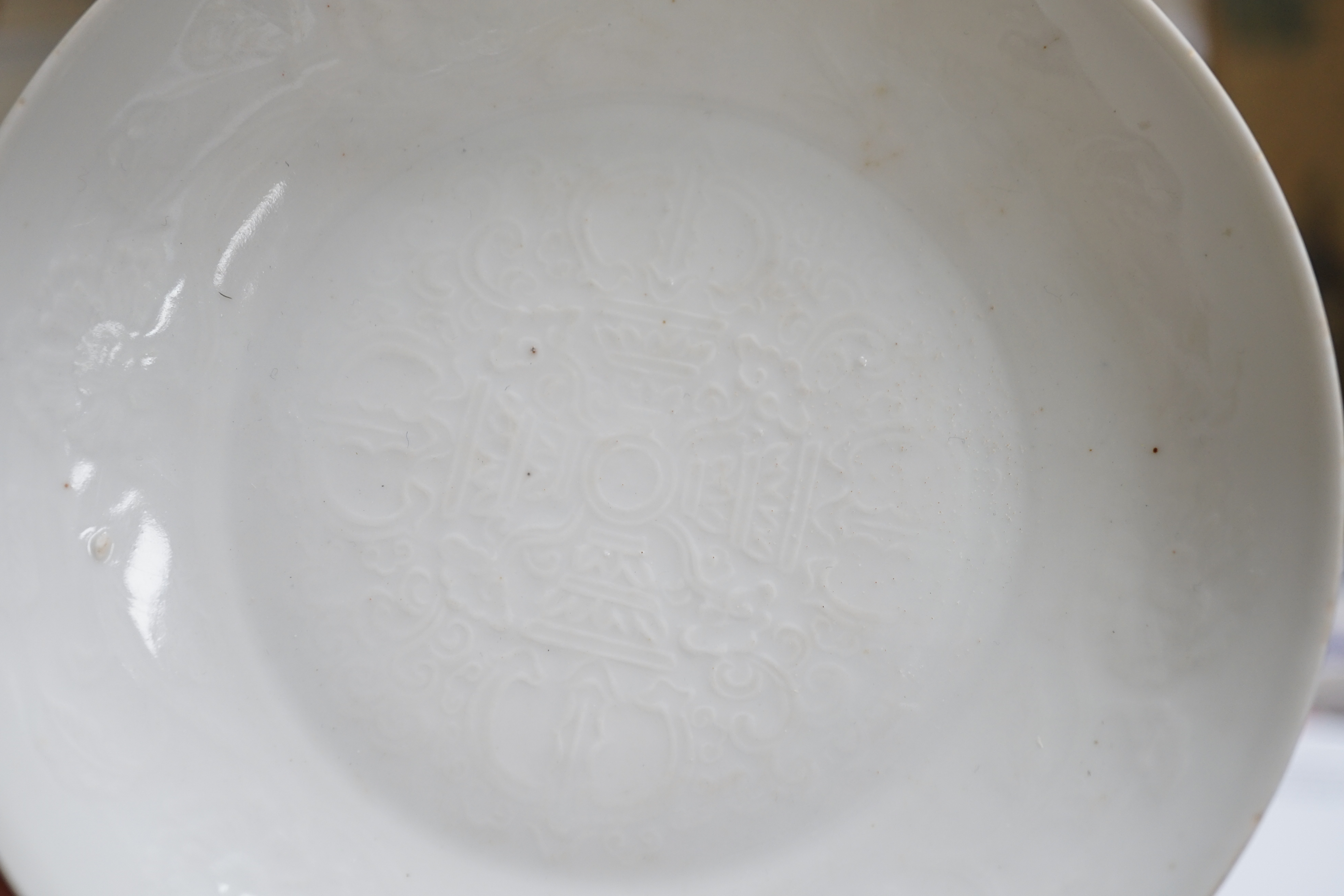A Chinese moulded white glazed saucer dish, Yongle mark, Republic period